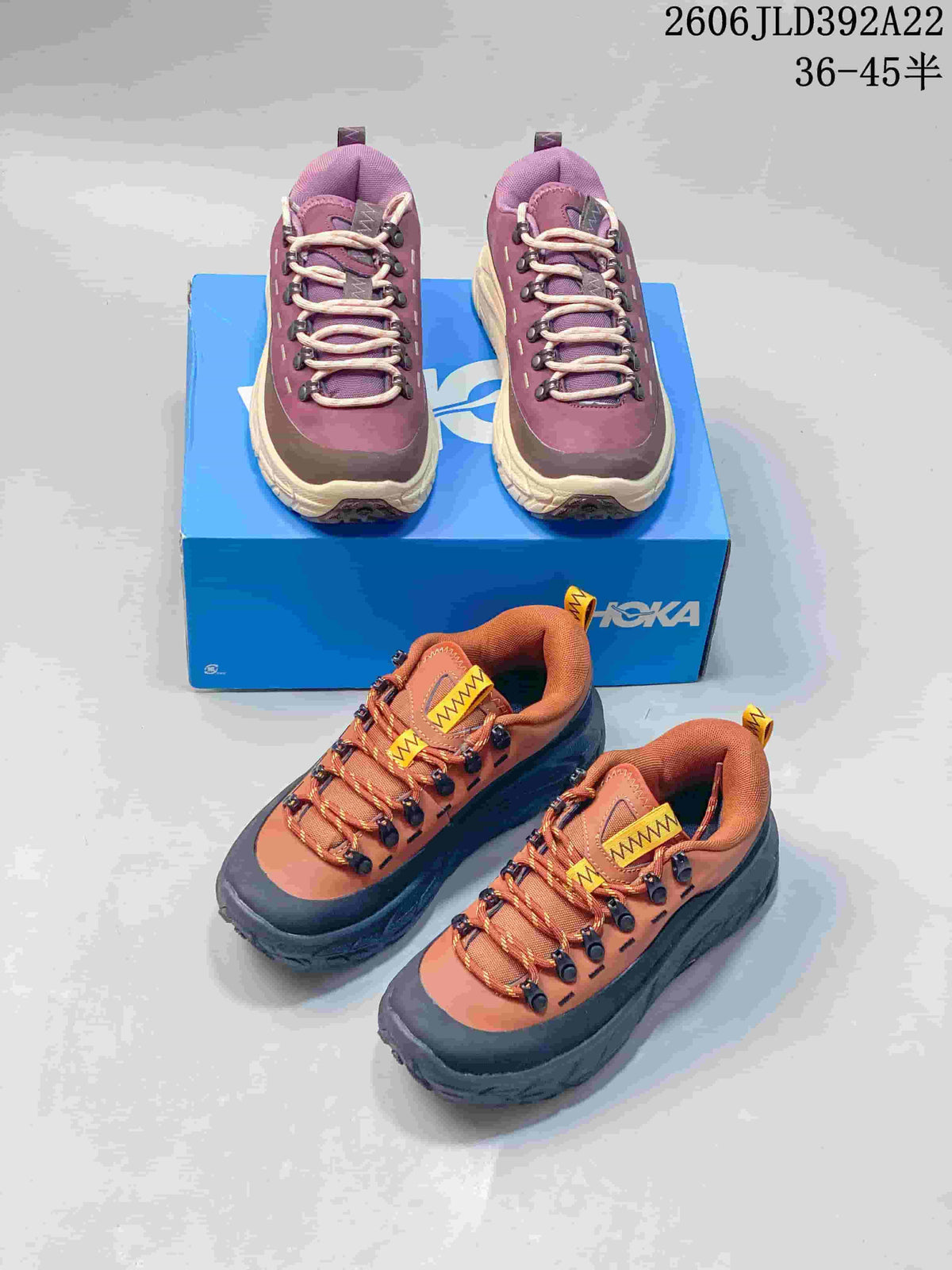 Plum and cream pair and rust orange and charcoal pair of HOKA low-top sneakers
