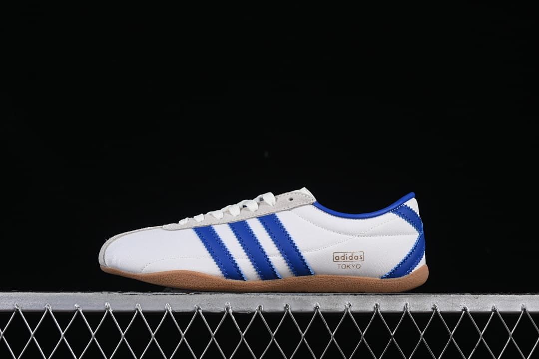 Side view of white adidas Tokyo W sneakers with blue stripes and gum-colored outsole