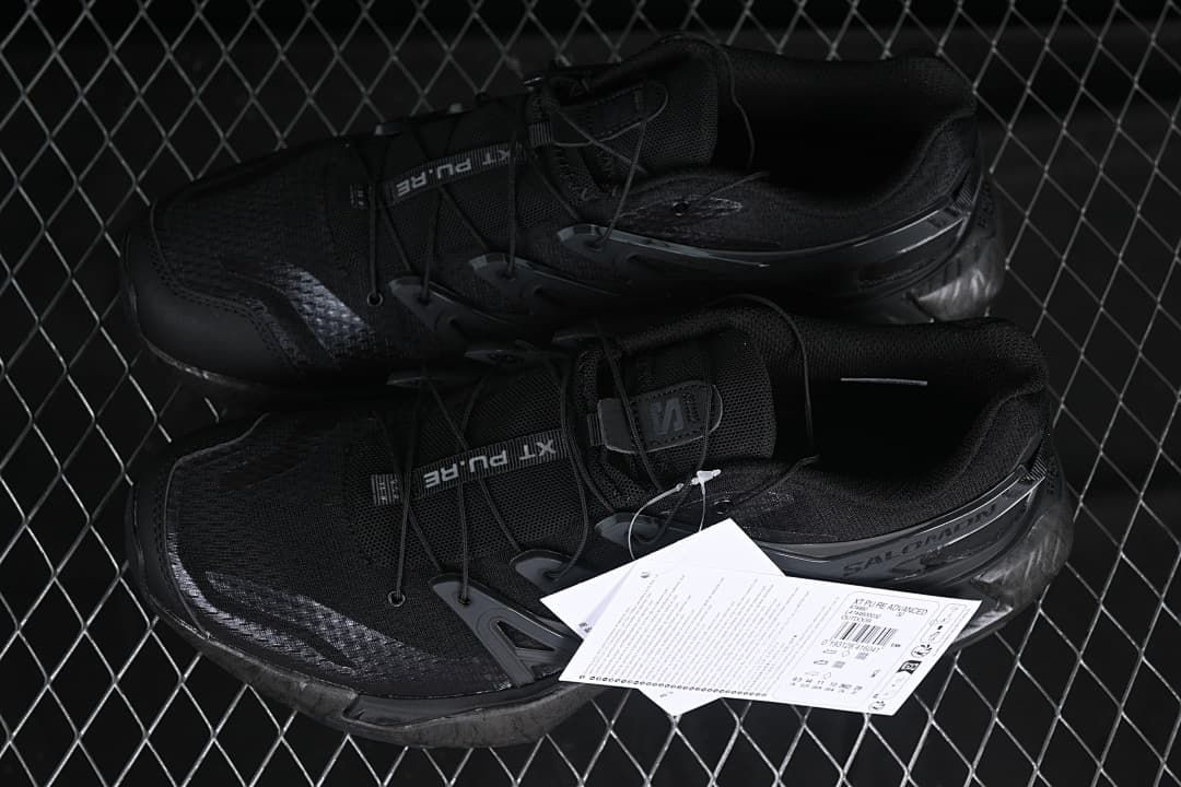Pair of black trail shoes shown with product tags.
