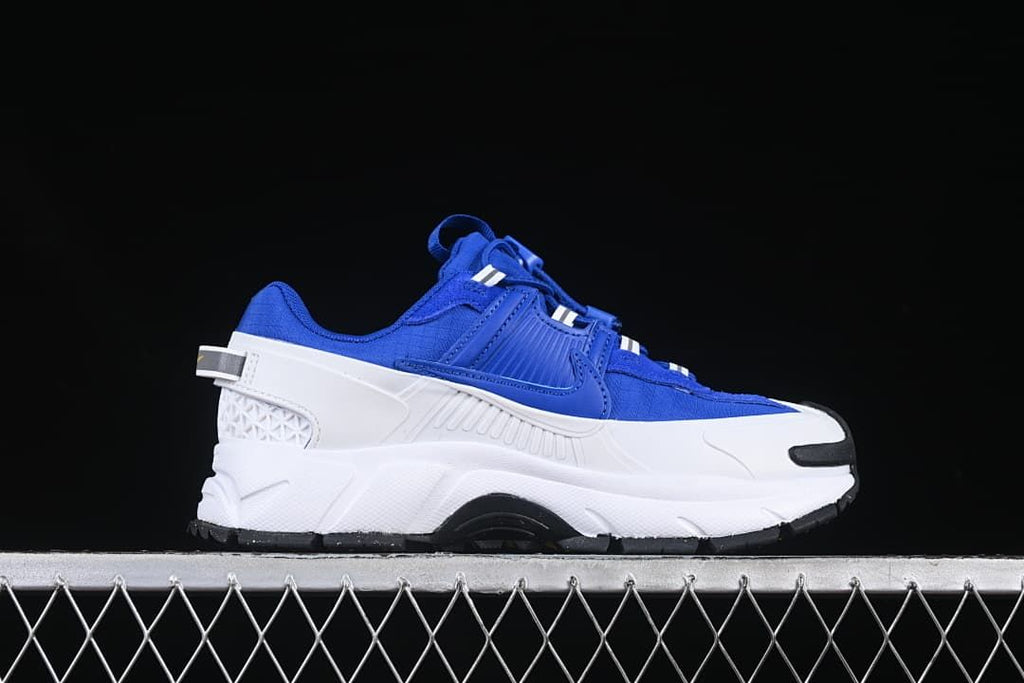 Side profile of the blue sneaker with white chunky midsole and black outsole