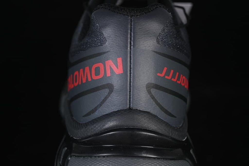 Rear view of the shoe with red Salomon and JJJJound lettering