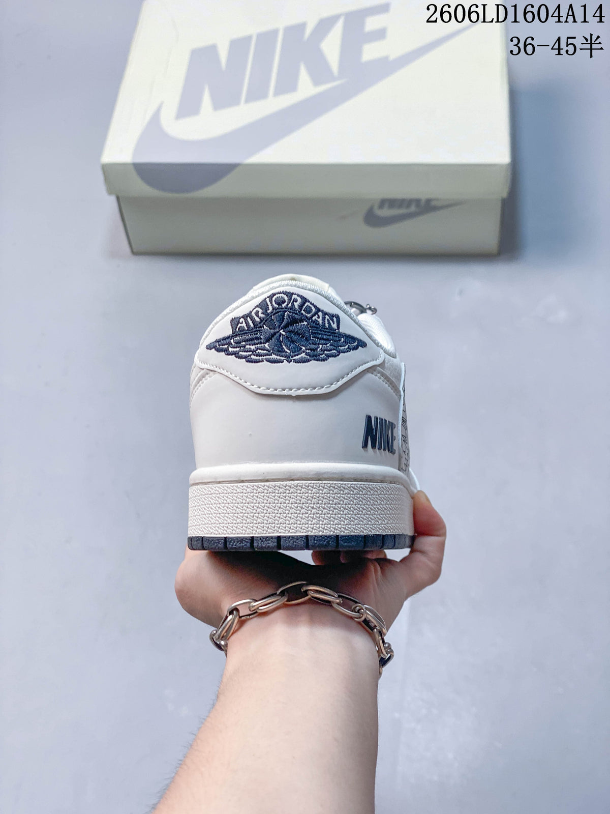 Rear view showing embroidered winged logo and navy outsole