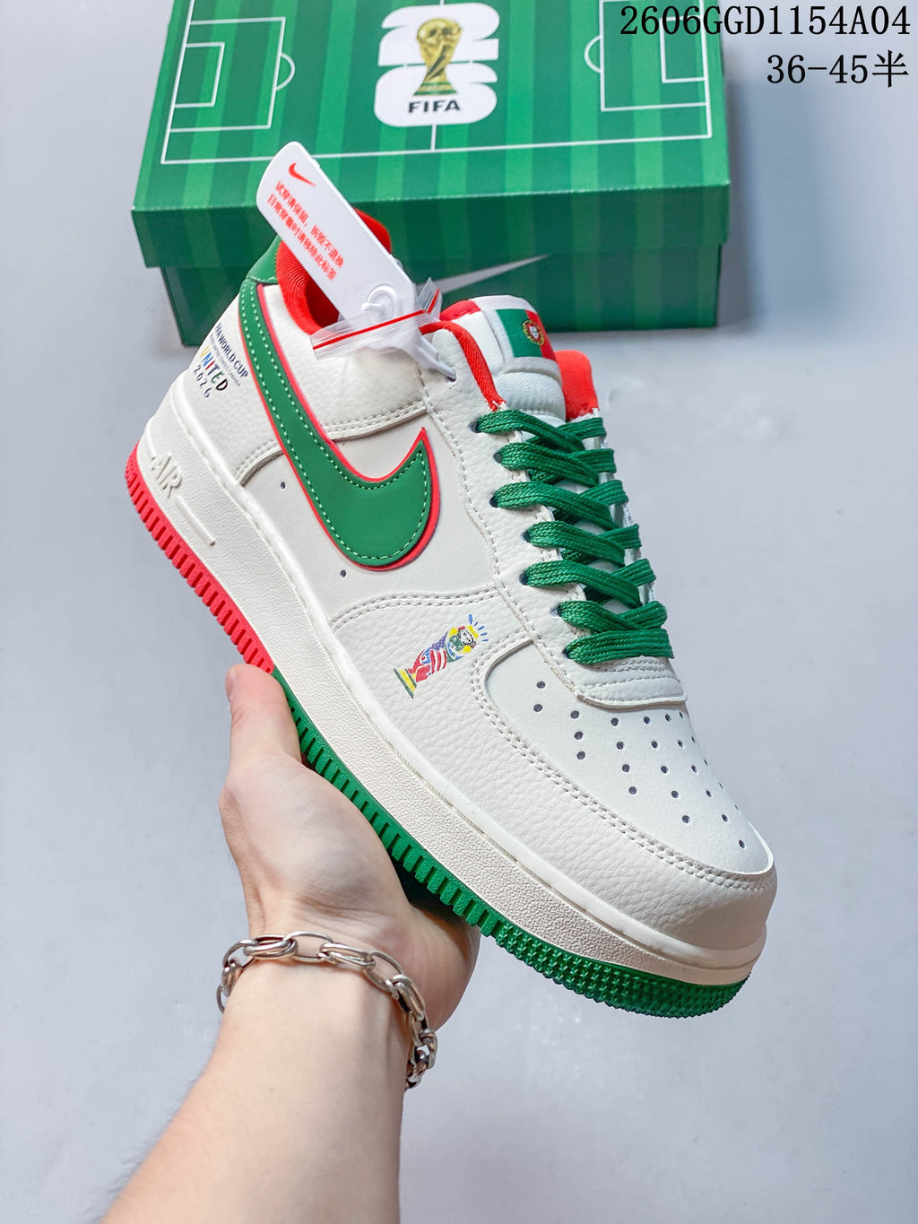 Angled view of the white sneaker with green side logo, green laces, and red and green accents