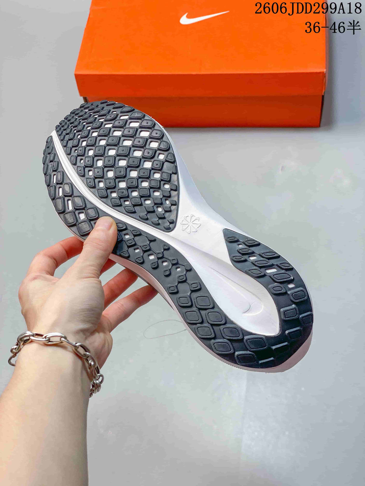 Underside of a Nike running shoe showing its patterned dark outsole
