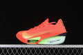 Side view of bright crimson Nike road racing shoe with yellow accents and mint-green midsole