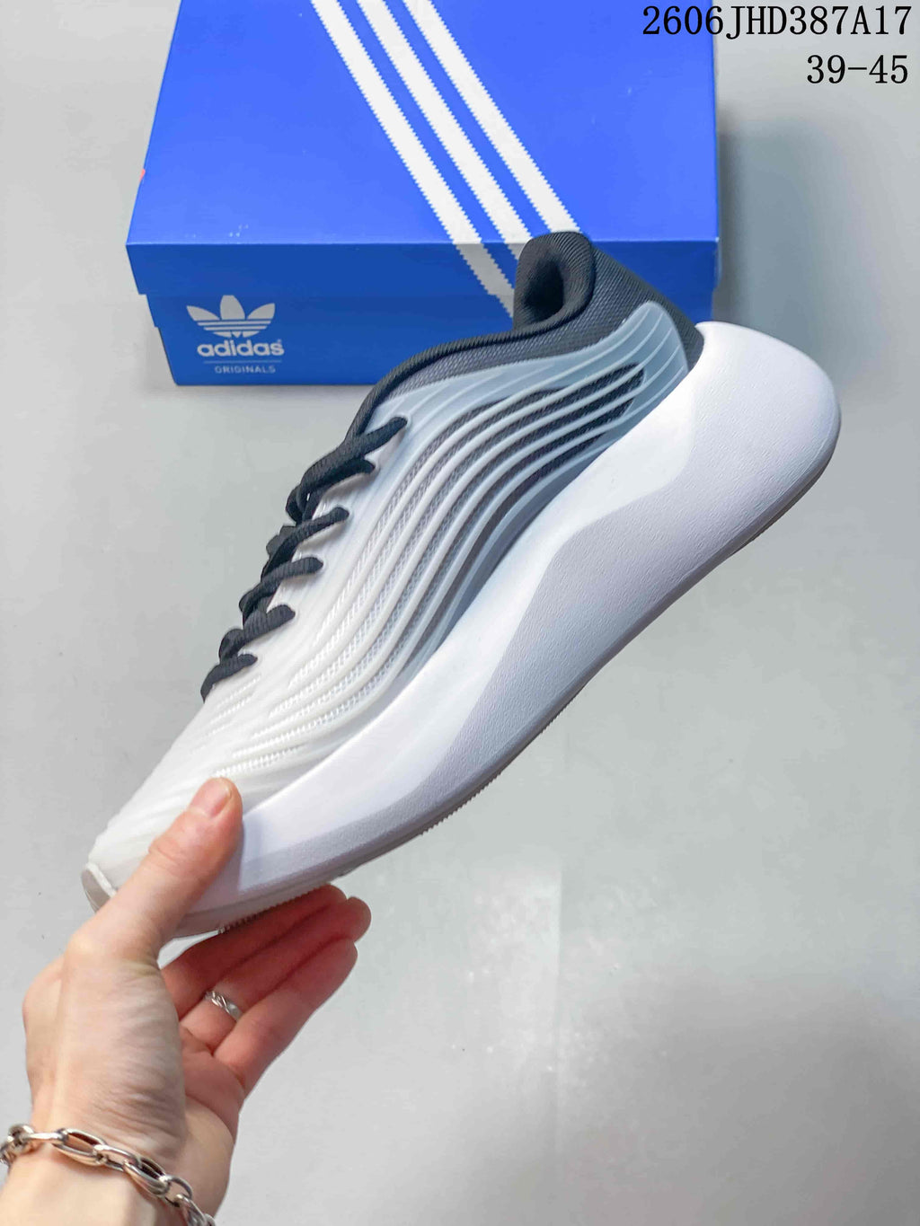 Side view of the white adidas Purechill V2 sneaker with grey detailing and a sculpted sole.
