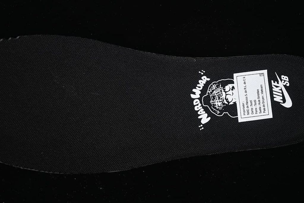 Close-up of the black insole with printed graphics and a label.