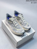 Pair of grey HOKA Rocket X 3 shoes with pale accents displayed on a box.