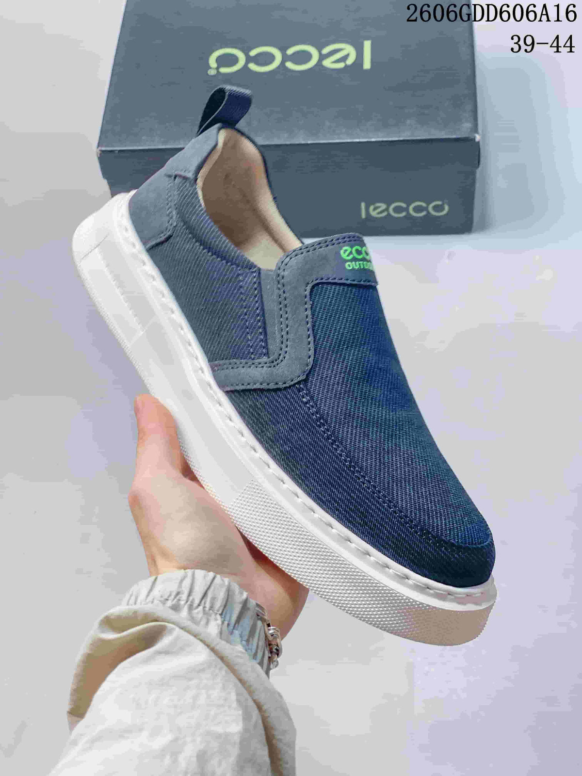 Angled close-up of a navy slip-on sneaker with a heel pull tab and white sole