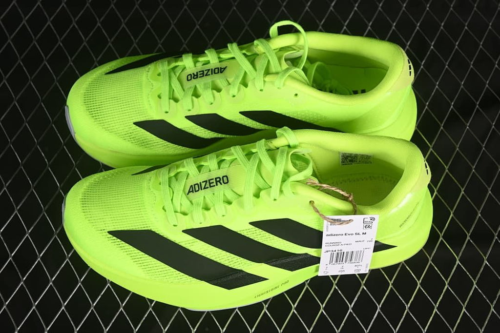 Pair of neon yellow Adidas Adizero Evo SL running shoes.