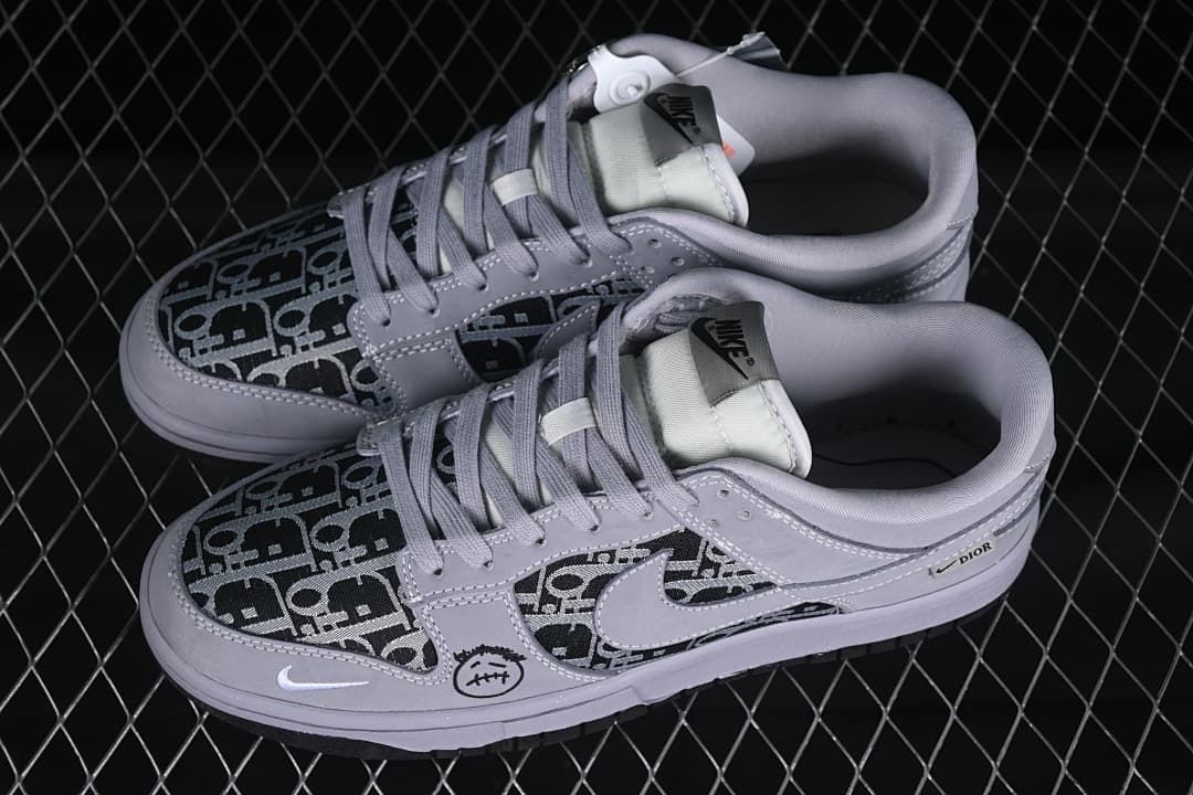 Pair of gray low-top sneakers with black patterned panels, viewed from above