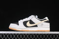 Side view of Nike SB Dunk Low Pro sneakers in black, light neutral, and cream with a gum-colored outsole.