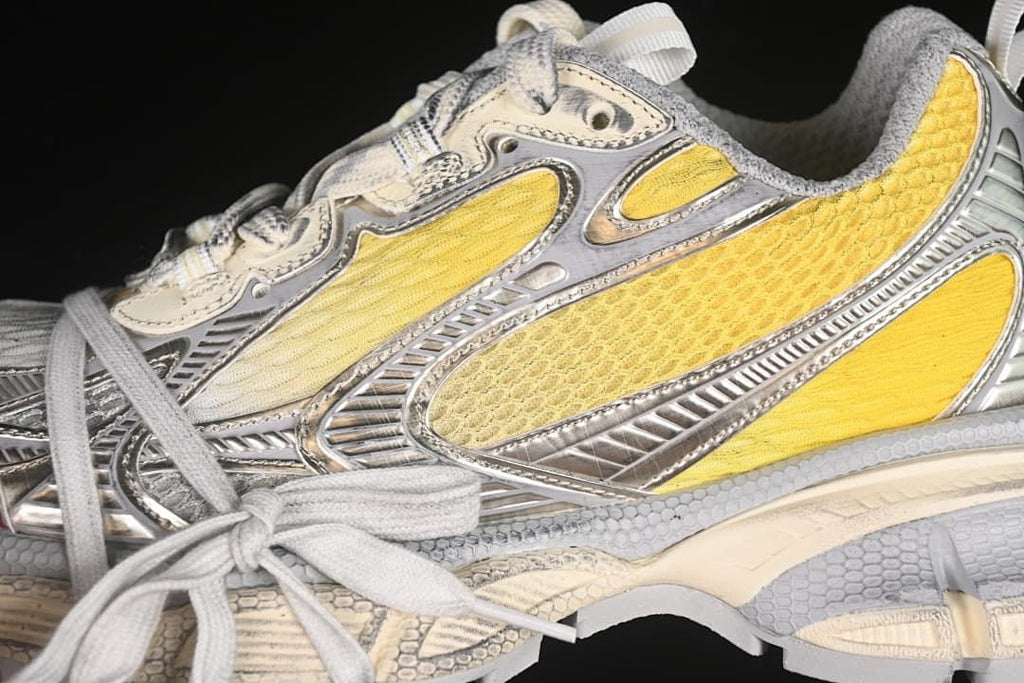Close-up of the yellow and gray side panels and lace-up upper