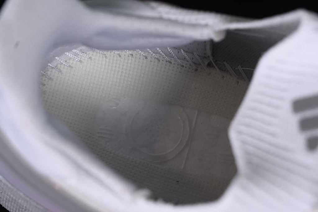 Close-up view inside the white running shoe