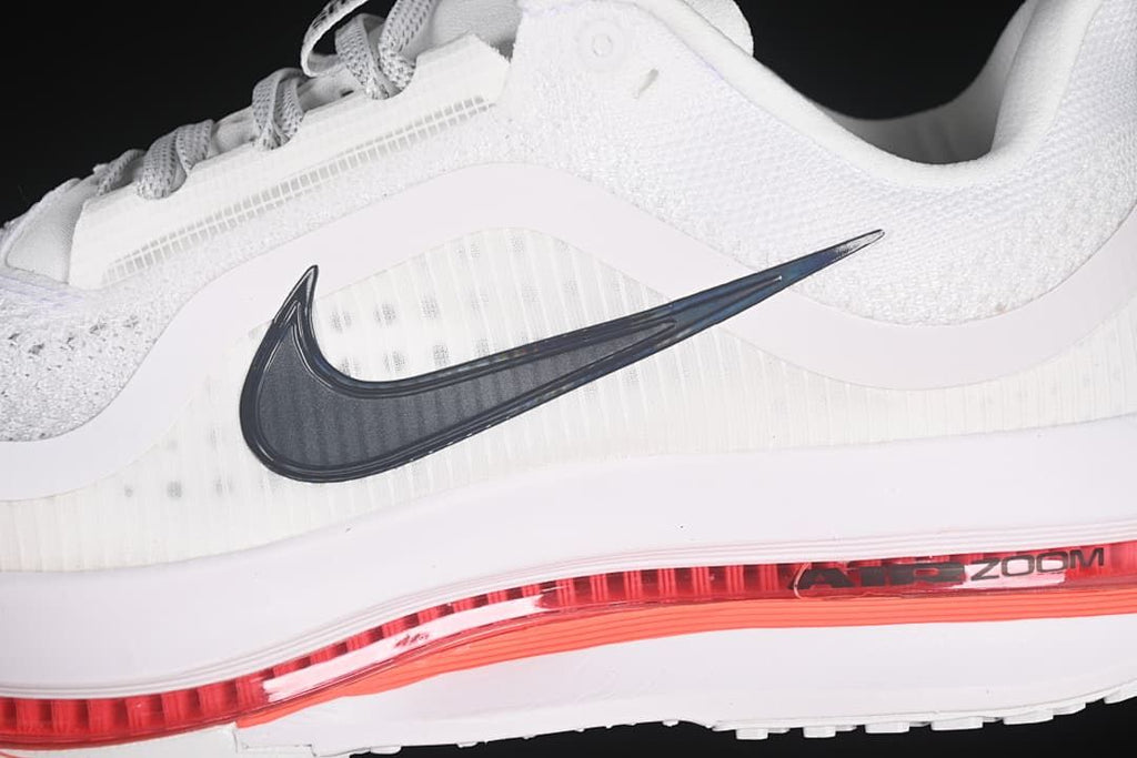 Close-up of the dark Swoosh, mesh upper, and red midsole detail.