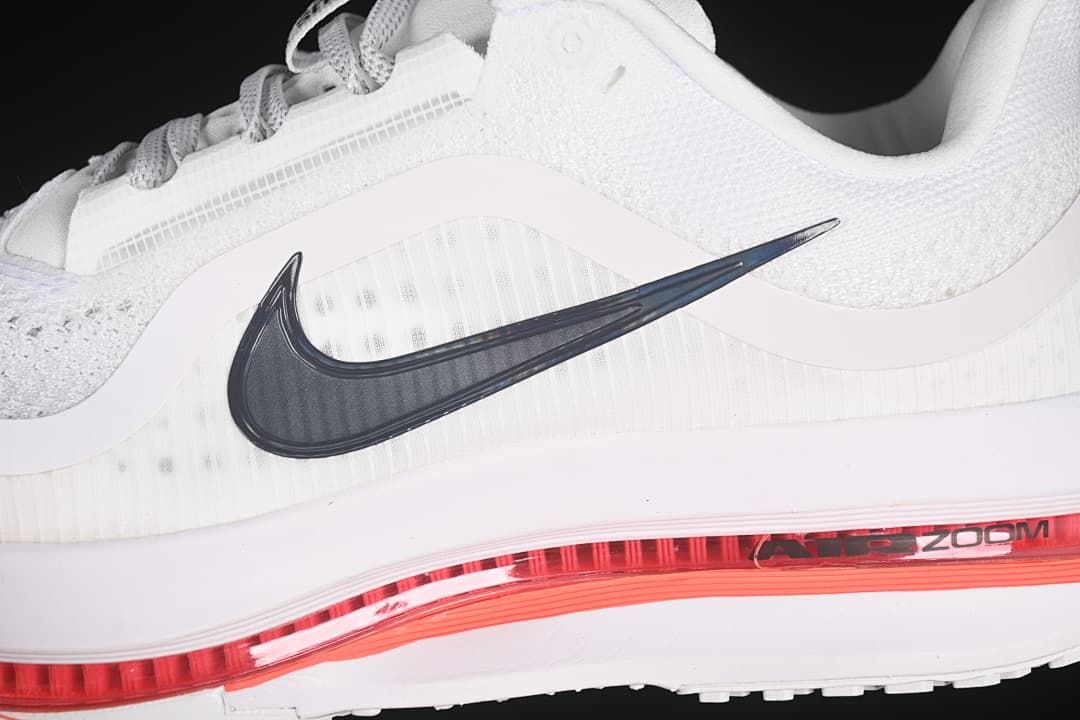 Close-up of the dark Swoosh, mesh upper, and red midsole detail.