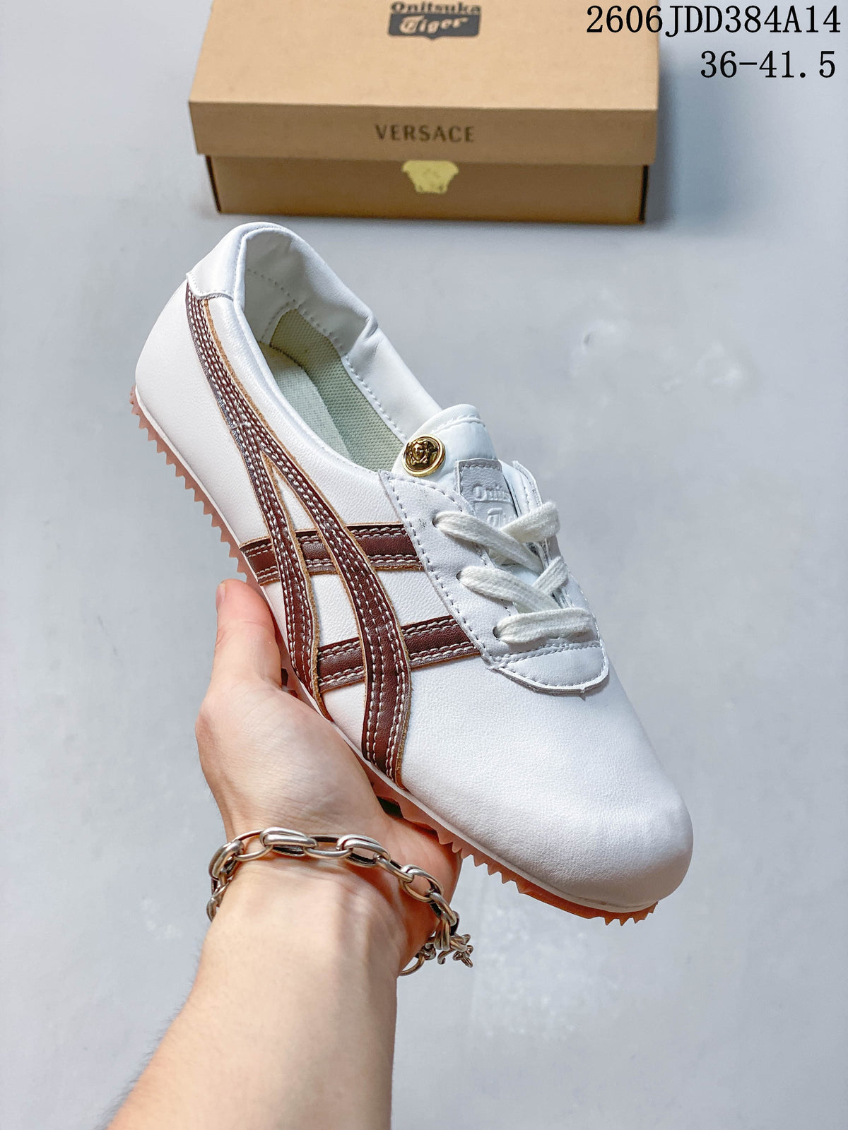 Angled view of the white sneaker with brown stripes and gum-colored outsole