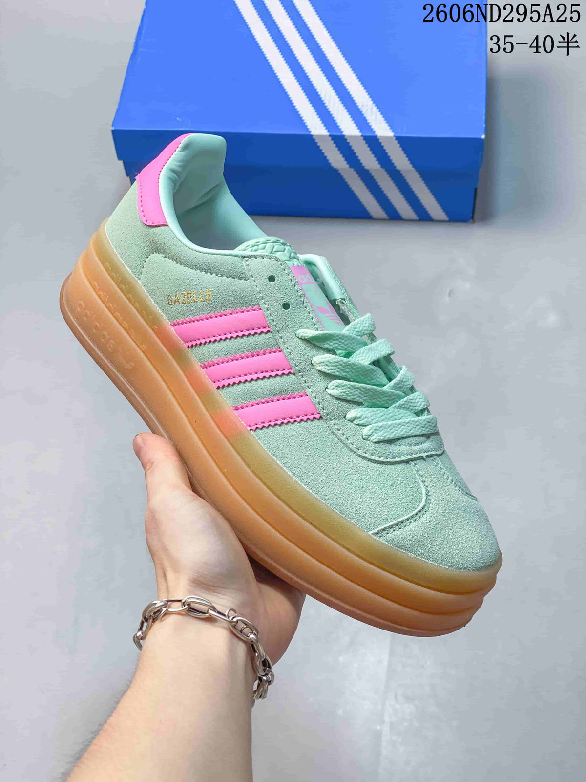 Side view showing the Gazelle lettering, pink stripes and raised gum-colored sole