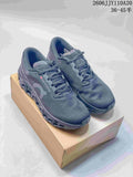 Pair of dark gray On Cloudmonster 3 shoes on a box, viewed from above and the front.