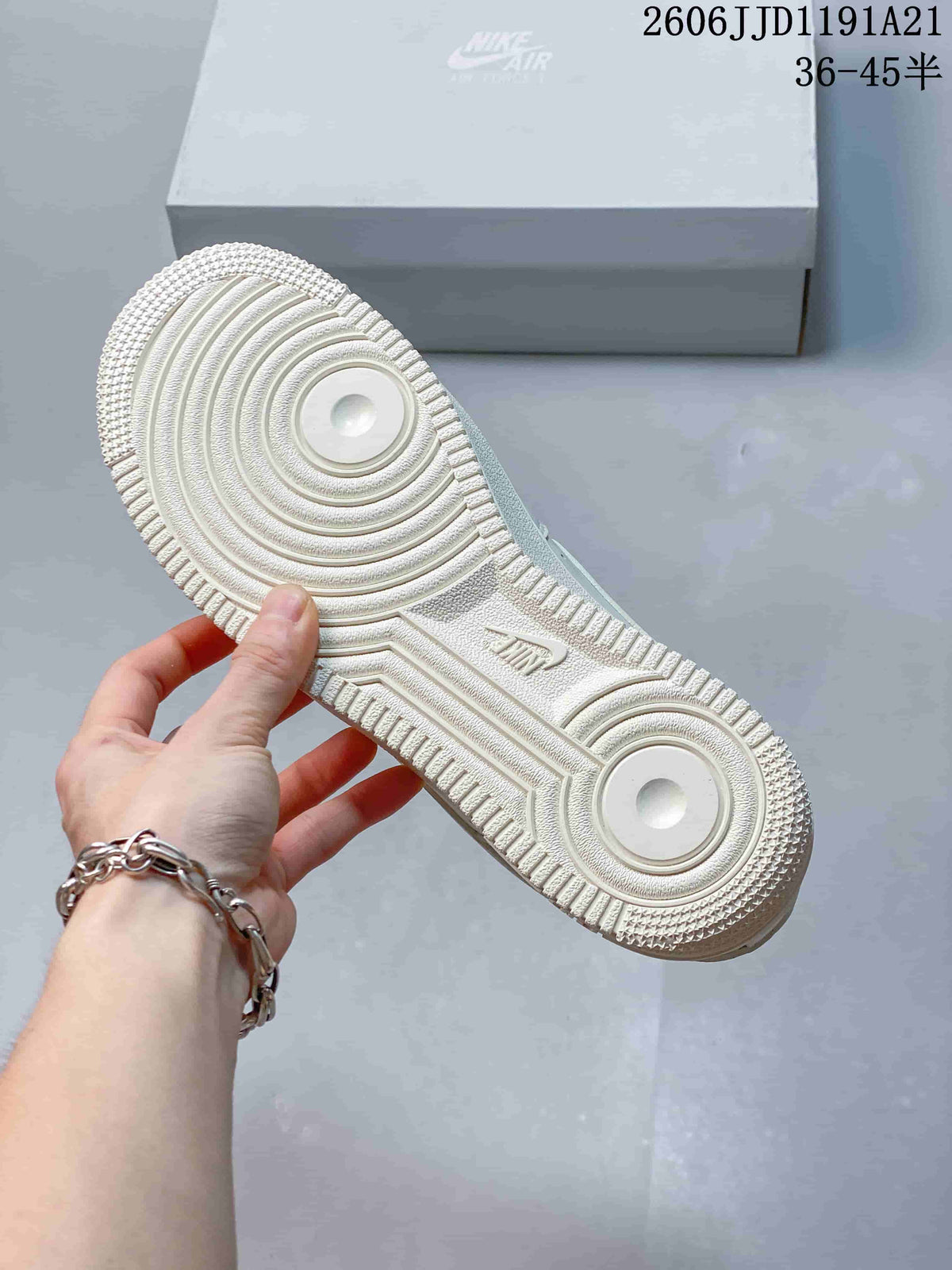 Underside view of the white sneaker outsole with circular traction patterns
