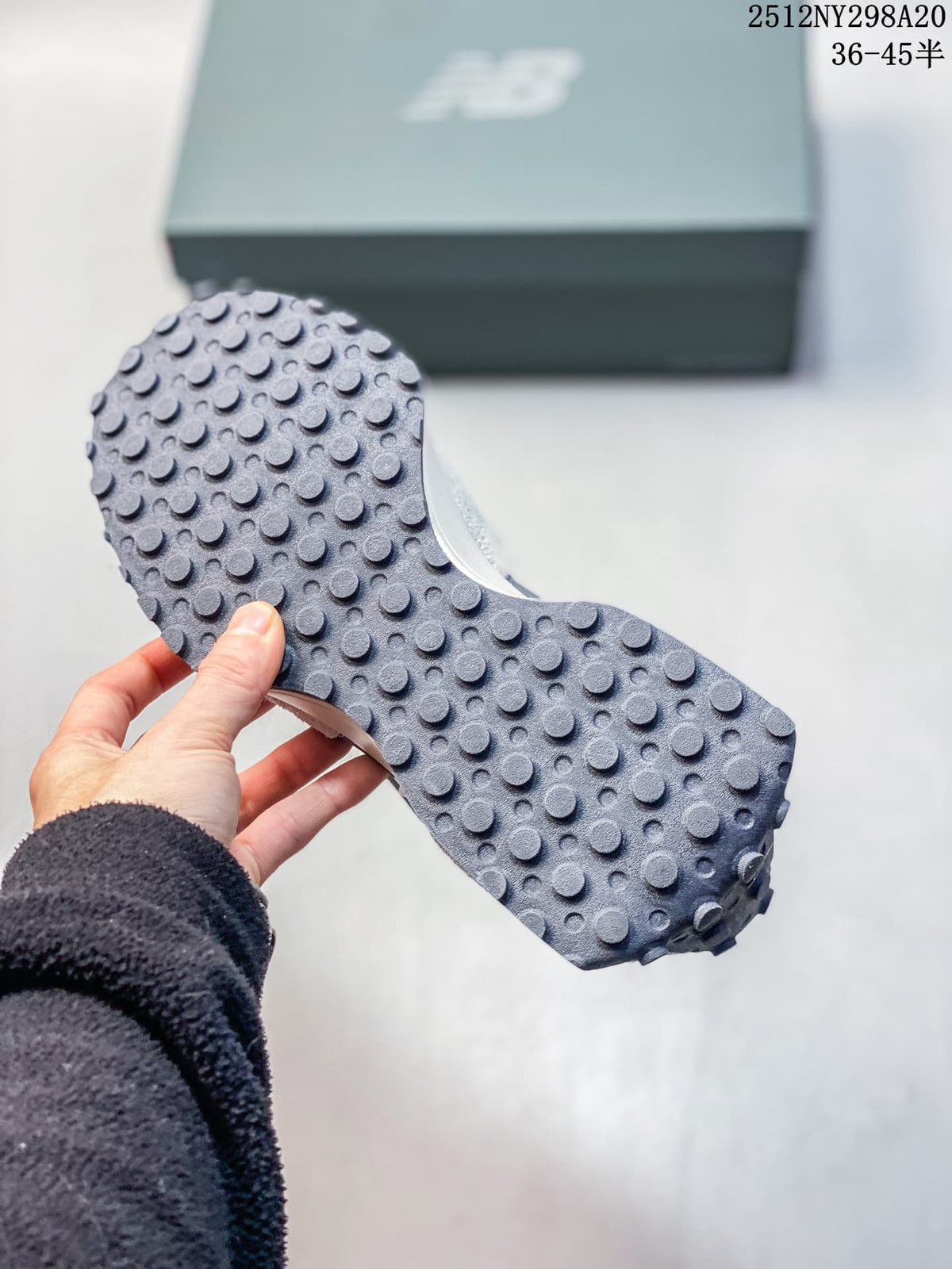 Close-up of the studded outsole on a gray and navy sneaker