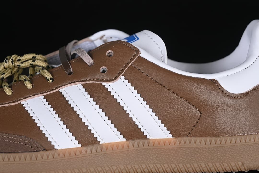 Close-up of the white three stripes, brown upper, and gum-colored sole.