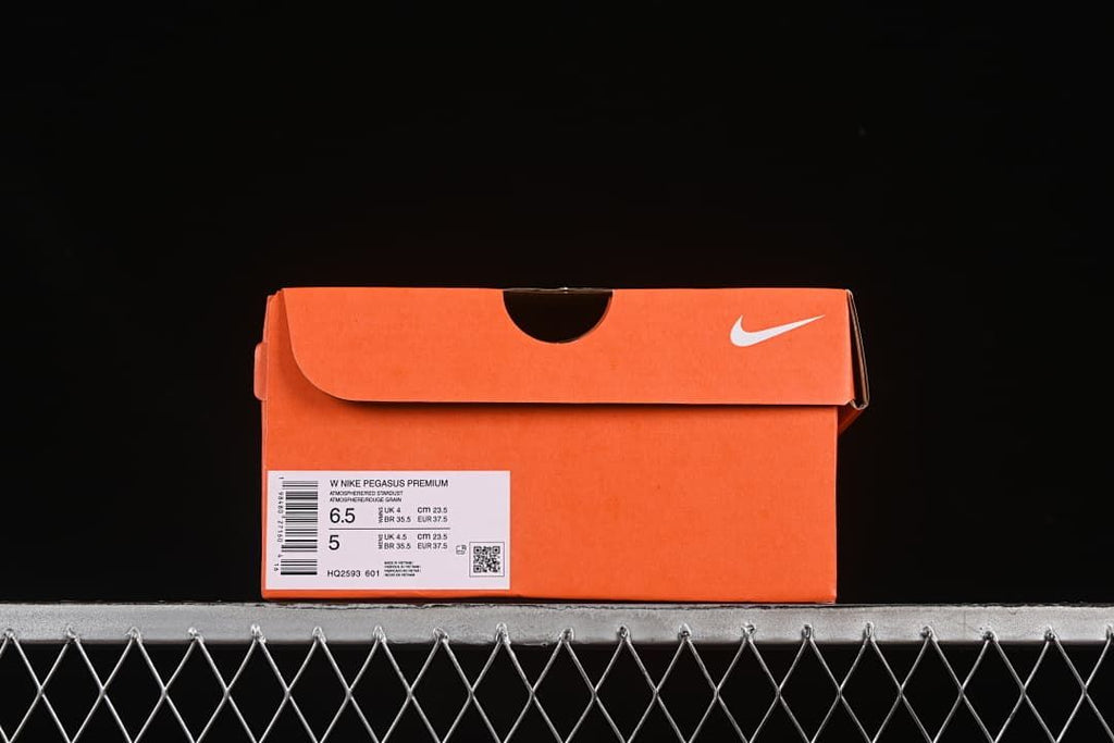 Orange shoe box with a label identifying Nike Pegasus Premium, size 6.5 and style code HQ2593-601