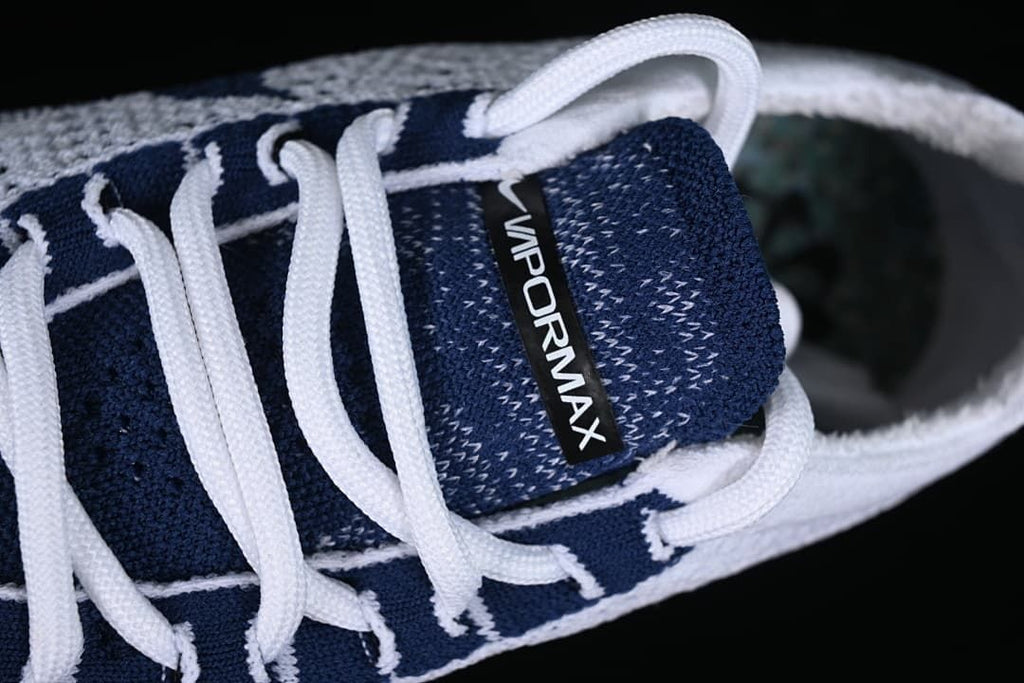 Close-up of the navy tongue and white laces
