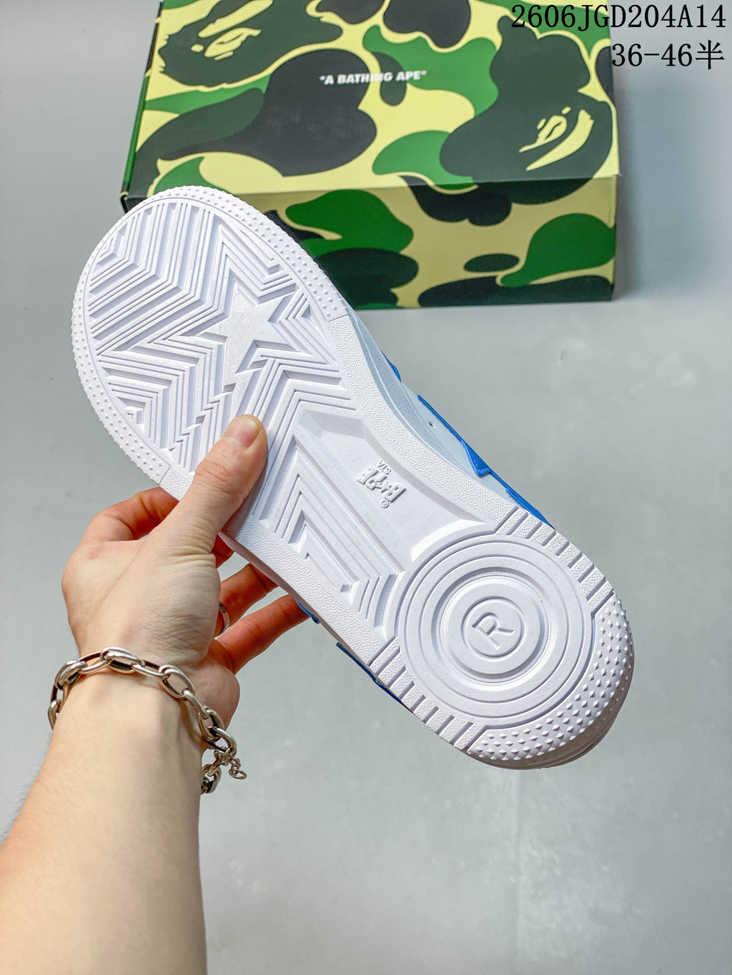 Underside of the white sneaker outsole with geometric tread