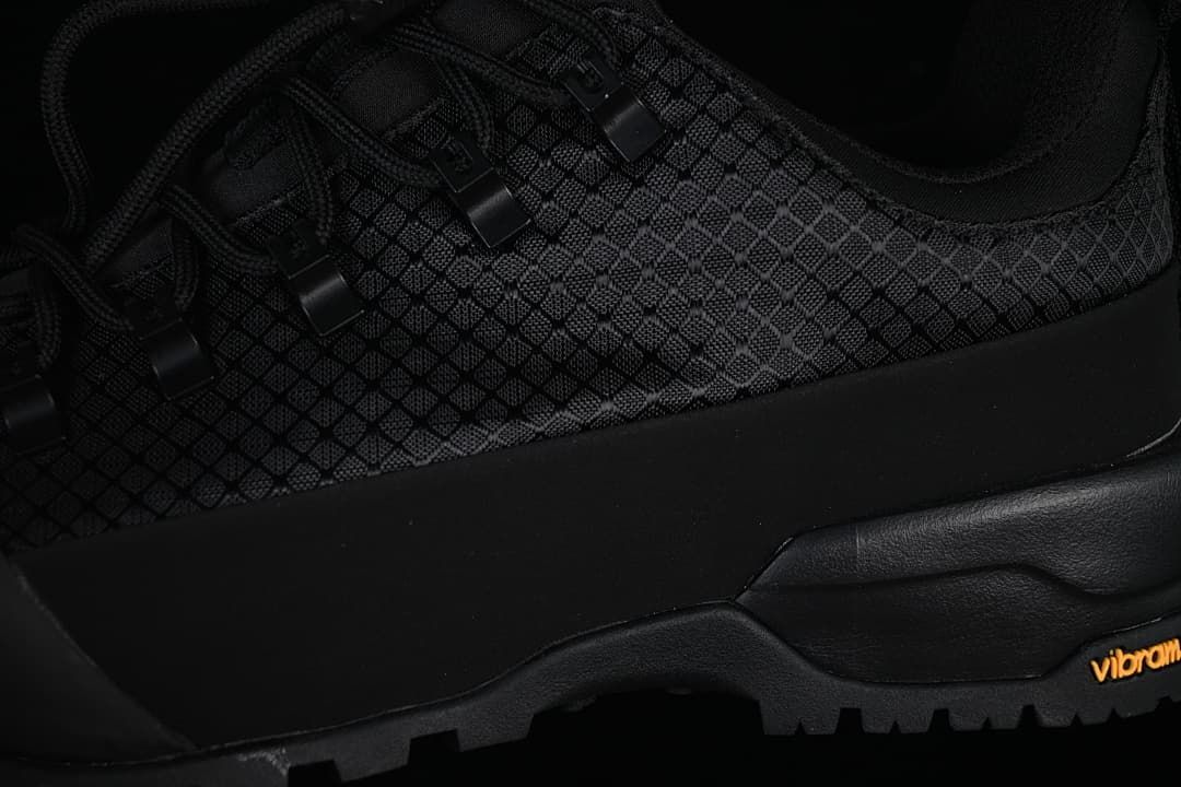 Close-up of the patterned upper, midsole, and Vibram branding.
