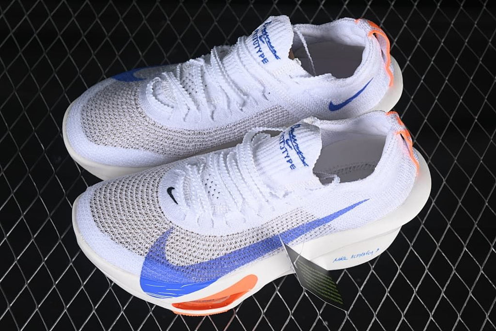 Pair of white running shoes with blue and orange accents