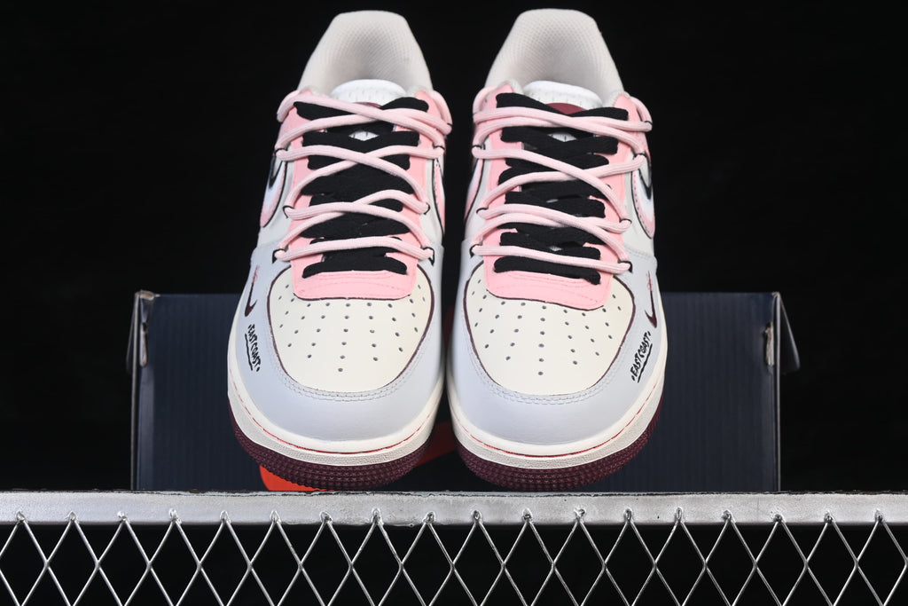 Front view showing perforated toes and contrasting pink and black laces