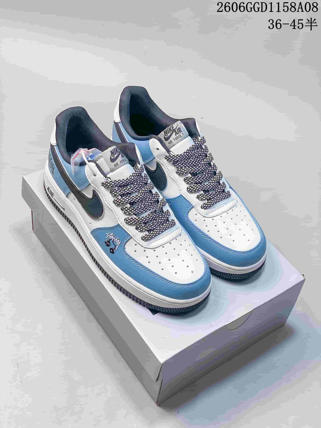Pair of white and light blue low-top sneakers with dark accents and patterned laces