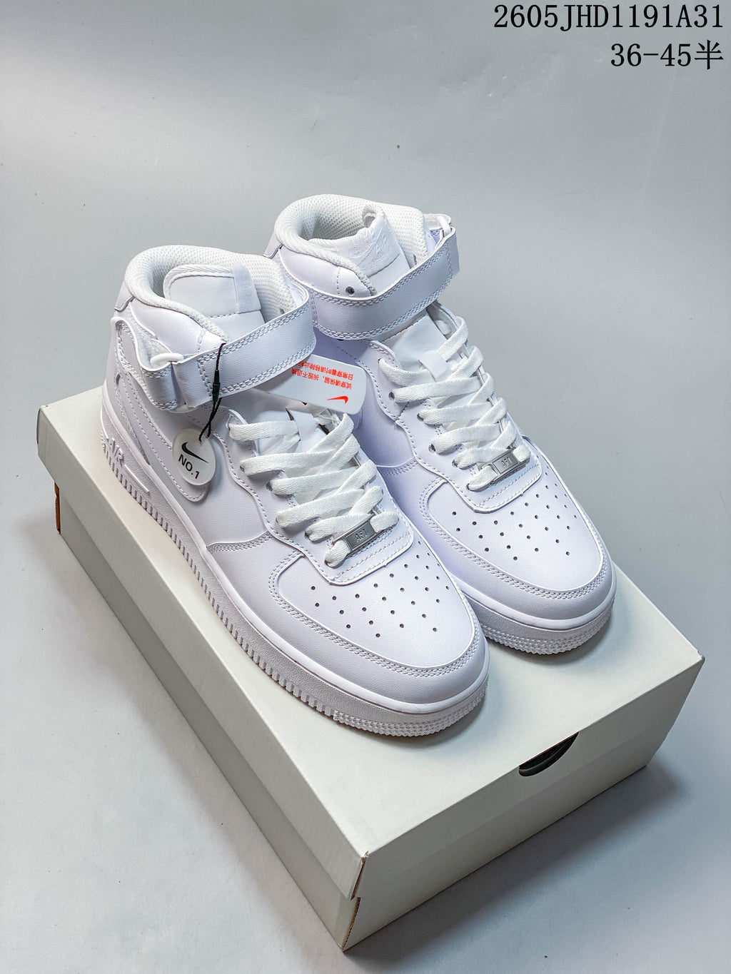 Pair of white Nike Air Force 1 high-top sneakers with ankle straps, shown from the front on a shoebox