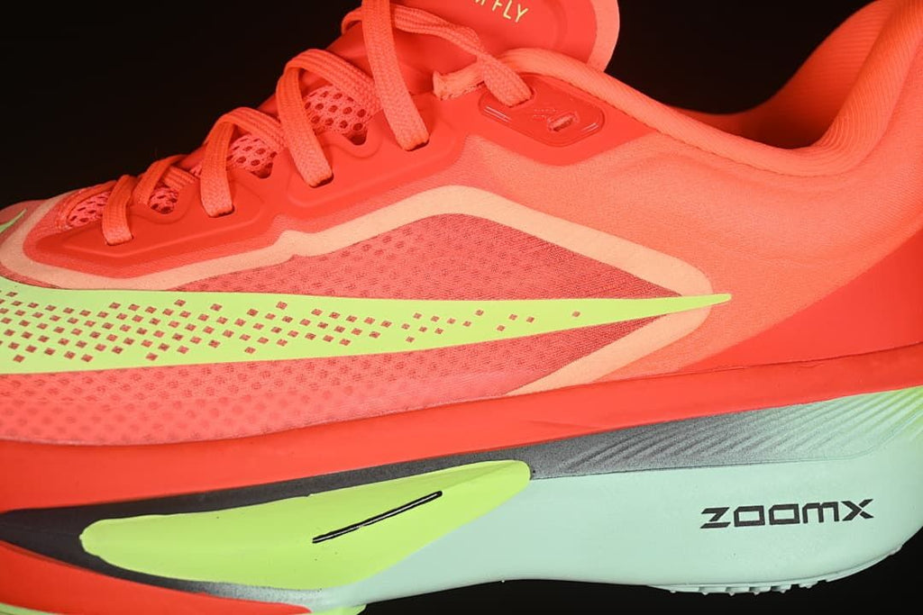 Close-up of side mesh pattern, lime Swoosh and ZoomX midsole branding