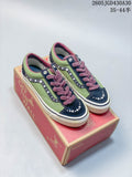 Pair of green and navy Vans LX Old Skool sneakers with pearl-like accents and plush mauve laces, displayed on a shoebox.
