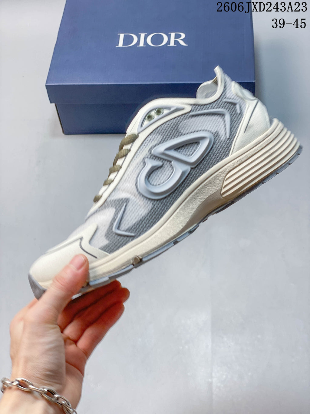 Side view of a gray Dior B30 low-top sneaker with light overlays and a chunky sole