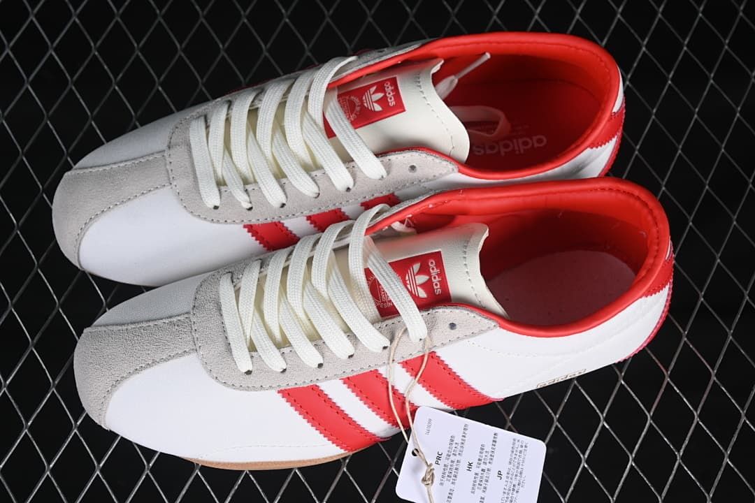Pair of white and red sneakers shown from above