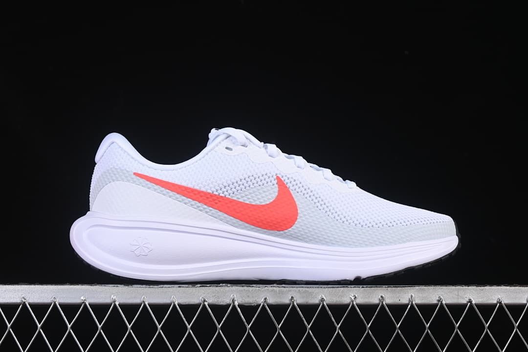 Side profile of the white shoe with coral-colored Swoosh