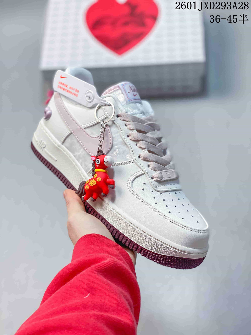 Angled view showing the sneaker's side details and dangling charm