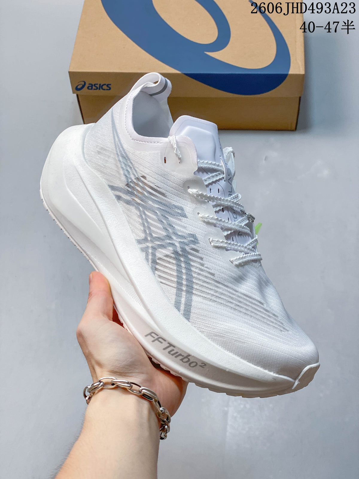 Side view of a white ASICS MAGIC SPEED FF TURBO running shoe.