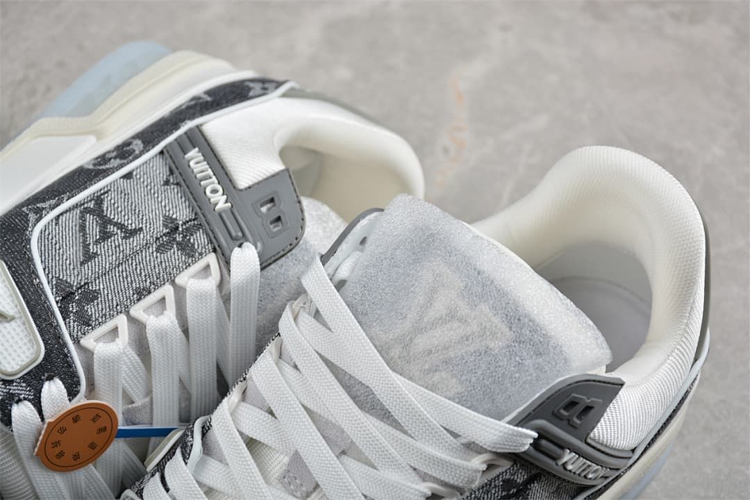 Close-up of the sneaker laces, tongue, collar, and patterned side panel.