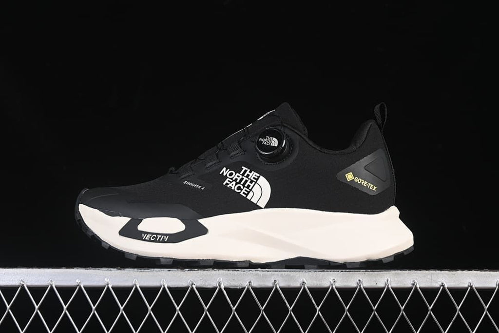 Side view of a black The North Face Vectiv Enduris 4 low-cut shoe.