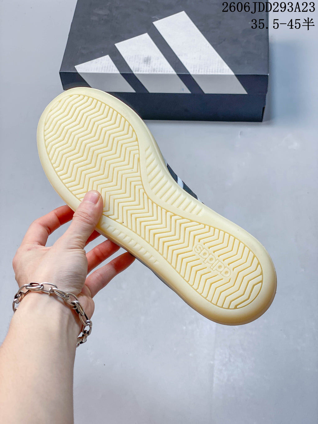 Underside of the Adidas sneaker showing a patterned sole