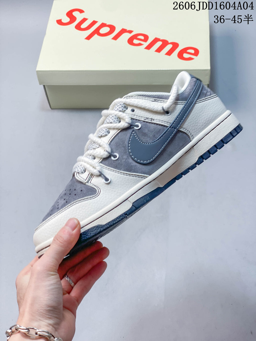 Side view of the gray and white Nike SB Dunk Low sneaker
