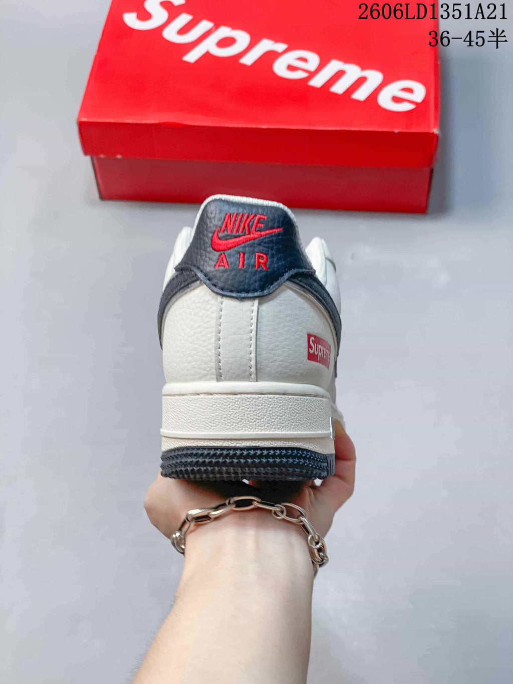 Rear view showing the heel branding, white upper, and dark outsole.