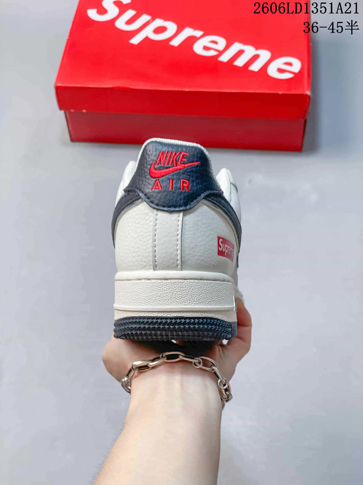 Rear view showing the heel branding, white upper, and dark outsole.