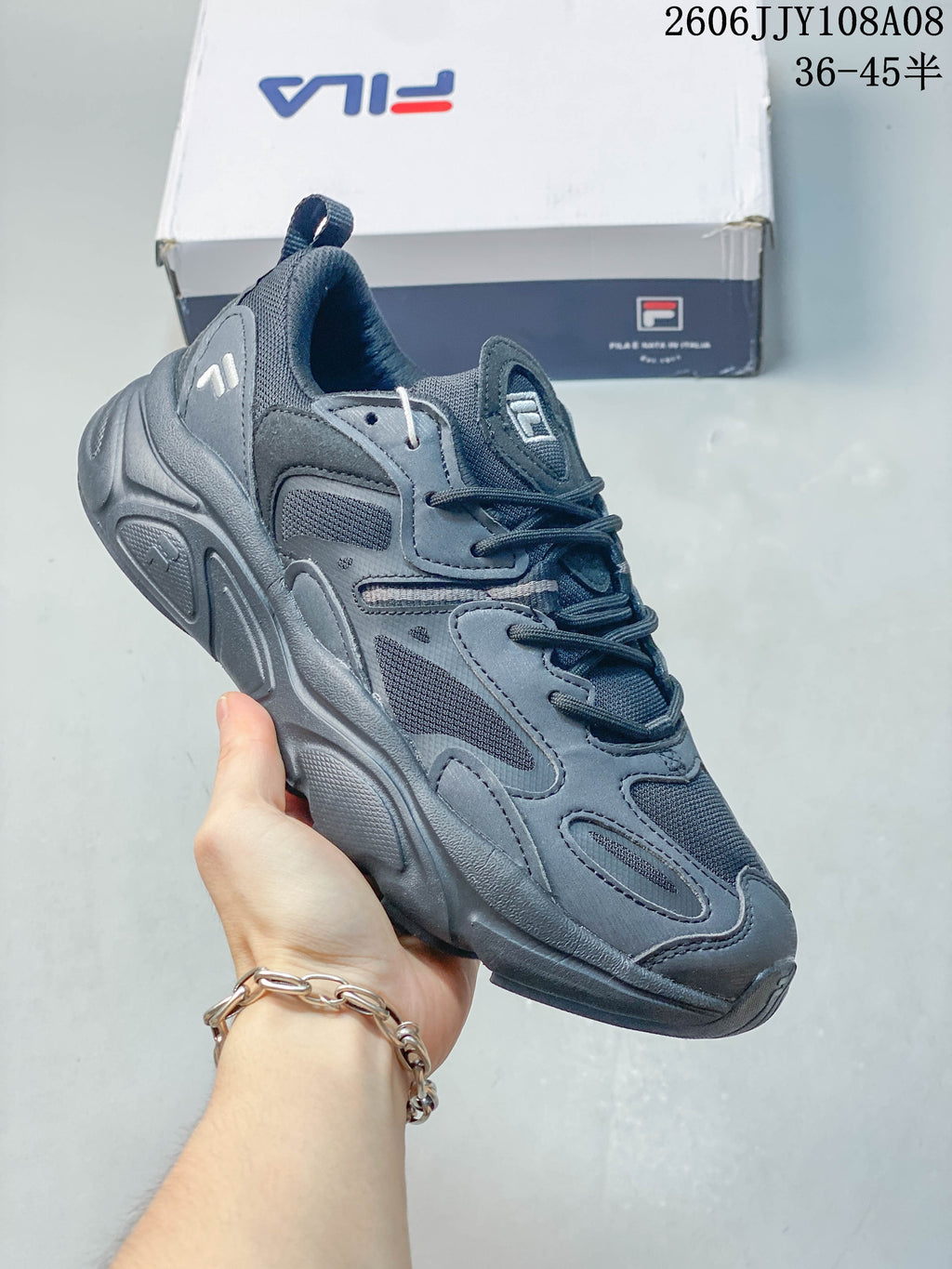 Dark gray FILA Fusion sneaker with a layered upper, mesh panels, and sculpted sole