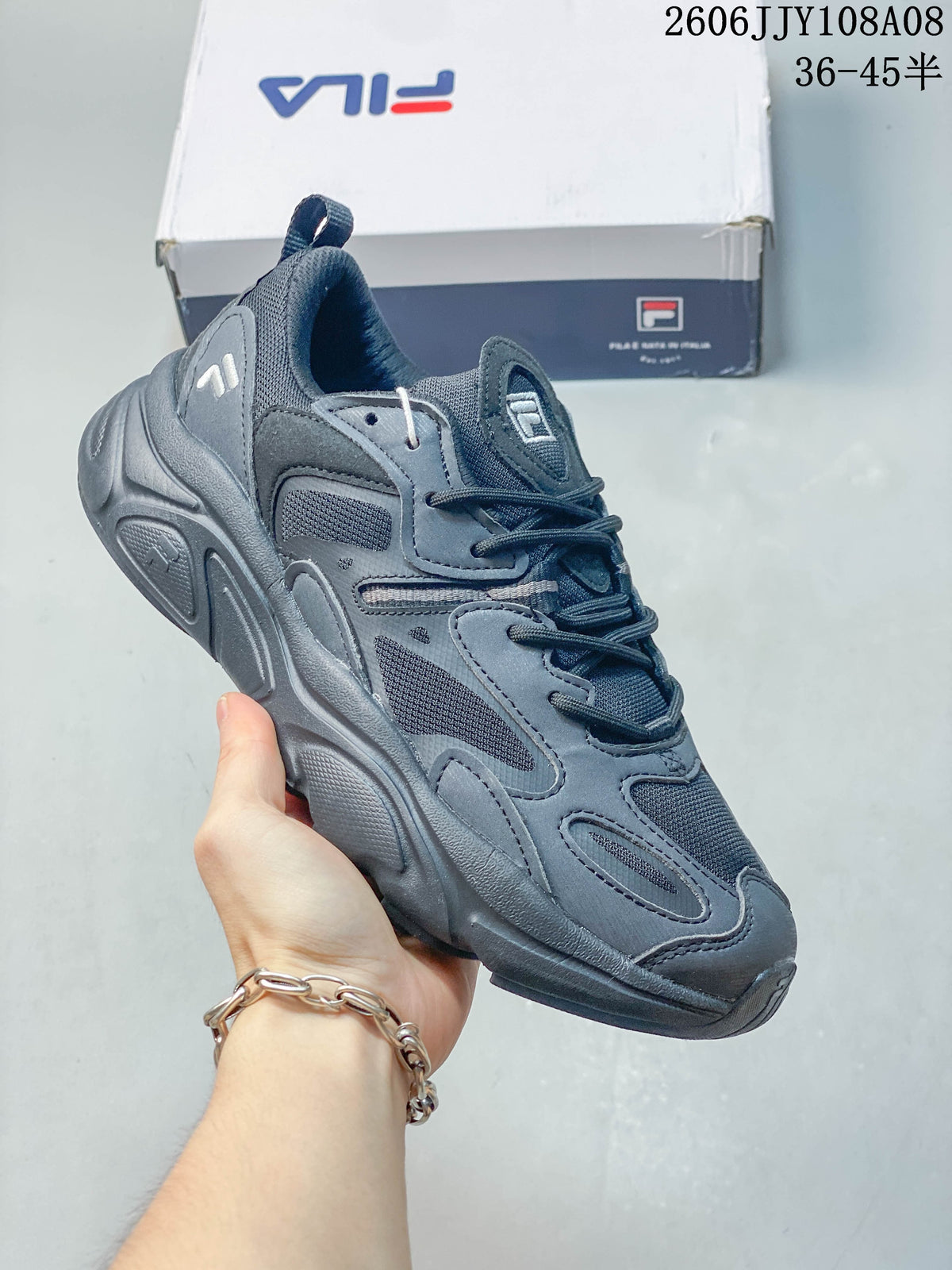 Dark gray FILA Fusion sneaker with a layered upper, mesh panels, and sculpted sole