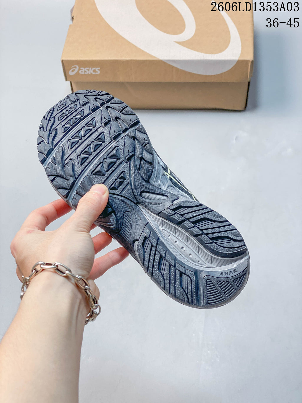 Close view of the patterned outsole on a grey ASICS GEL-170TR sneaker.